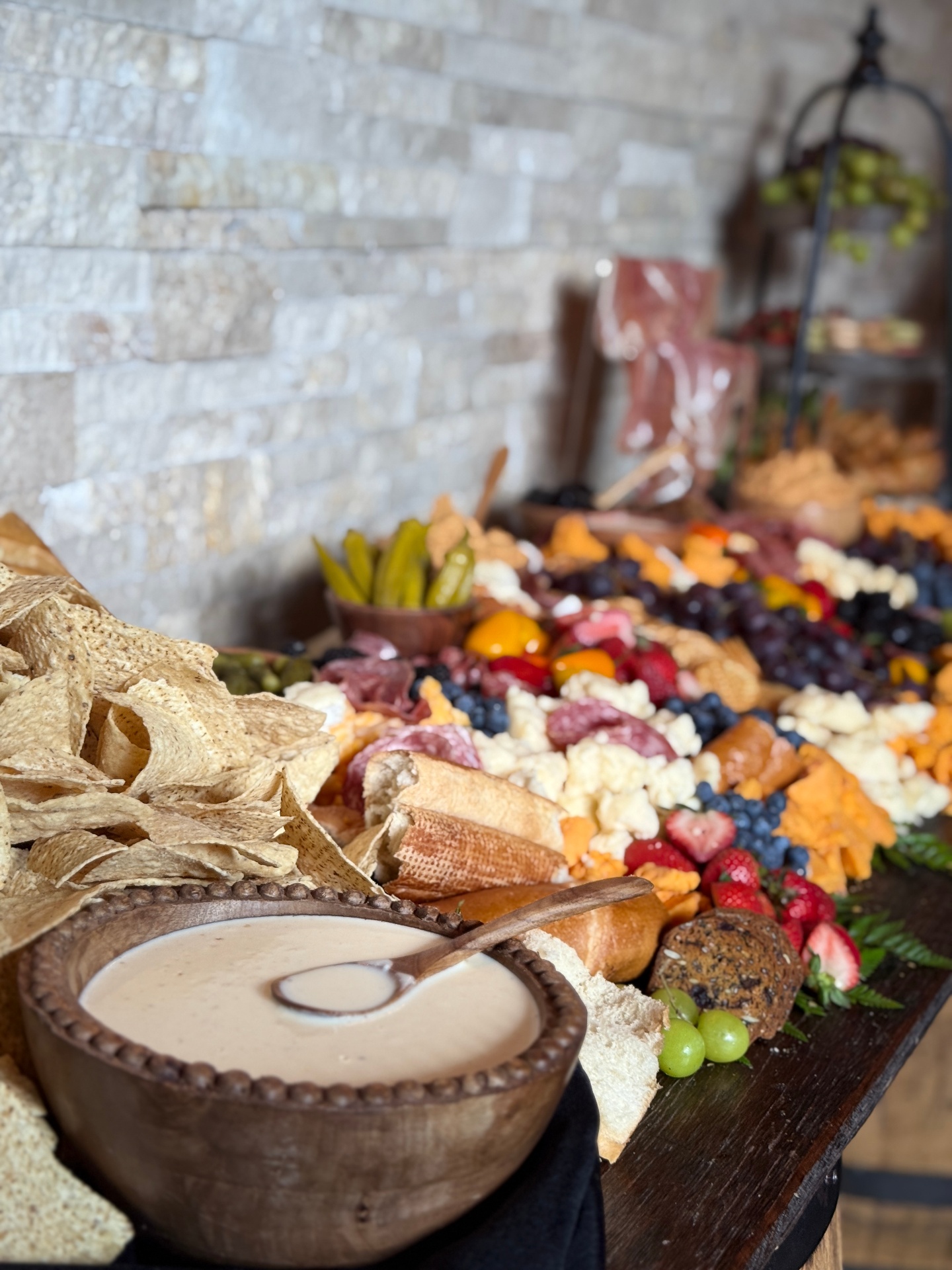 Lavish graze table with charcuterie, cheeses, and fruits