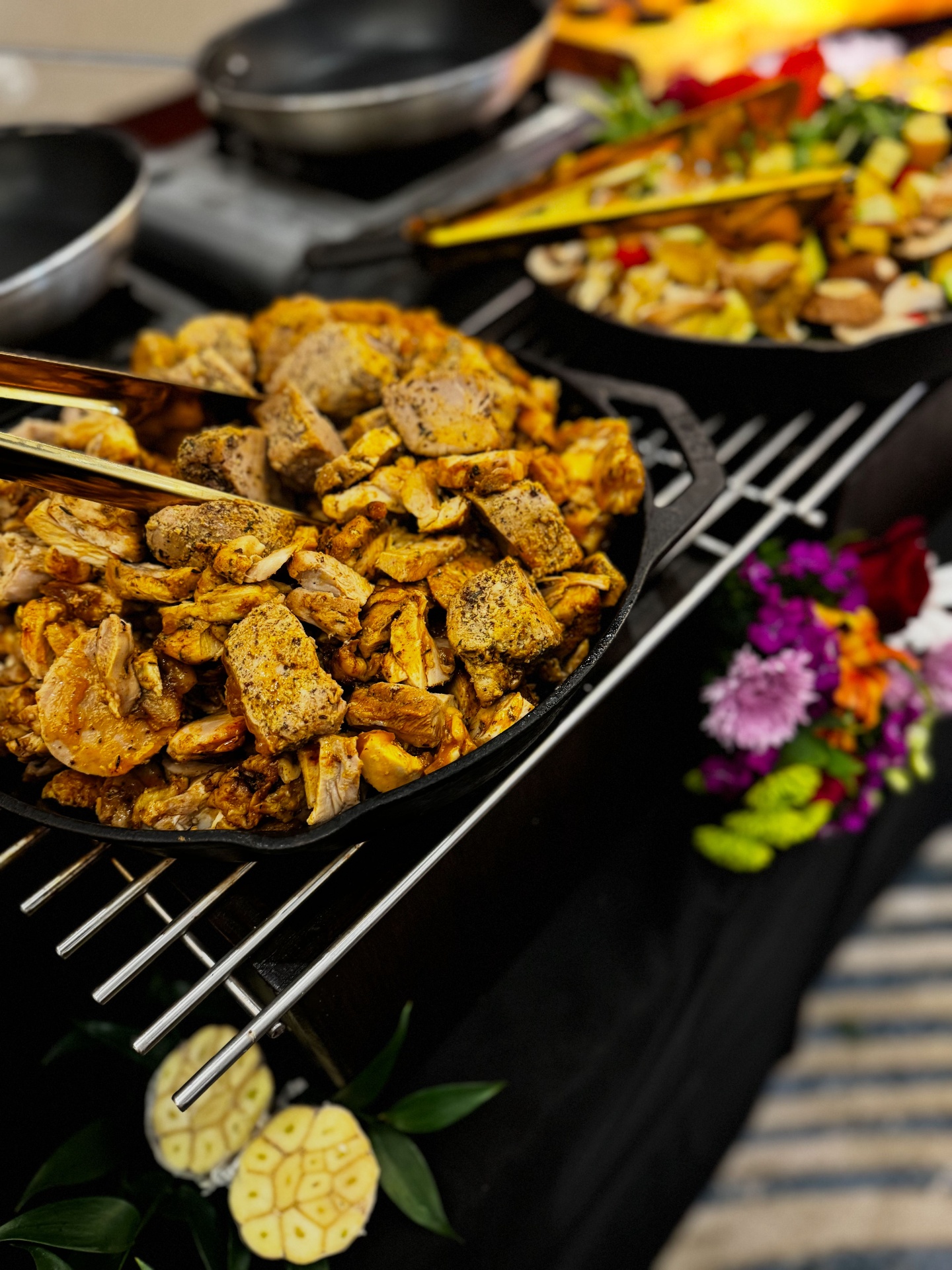 Catering chicken skillets on a grill with floral styling