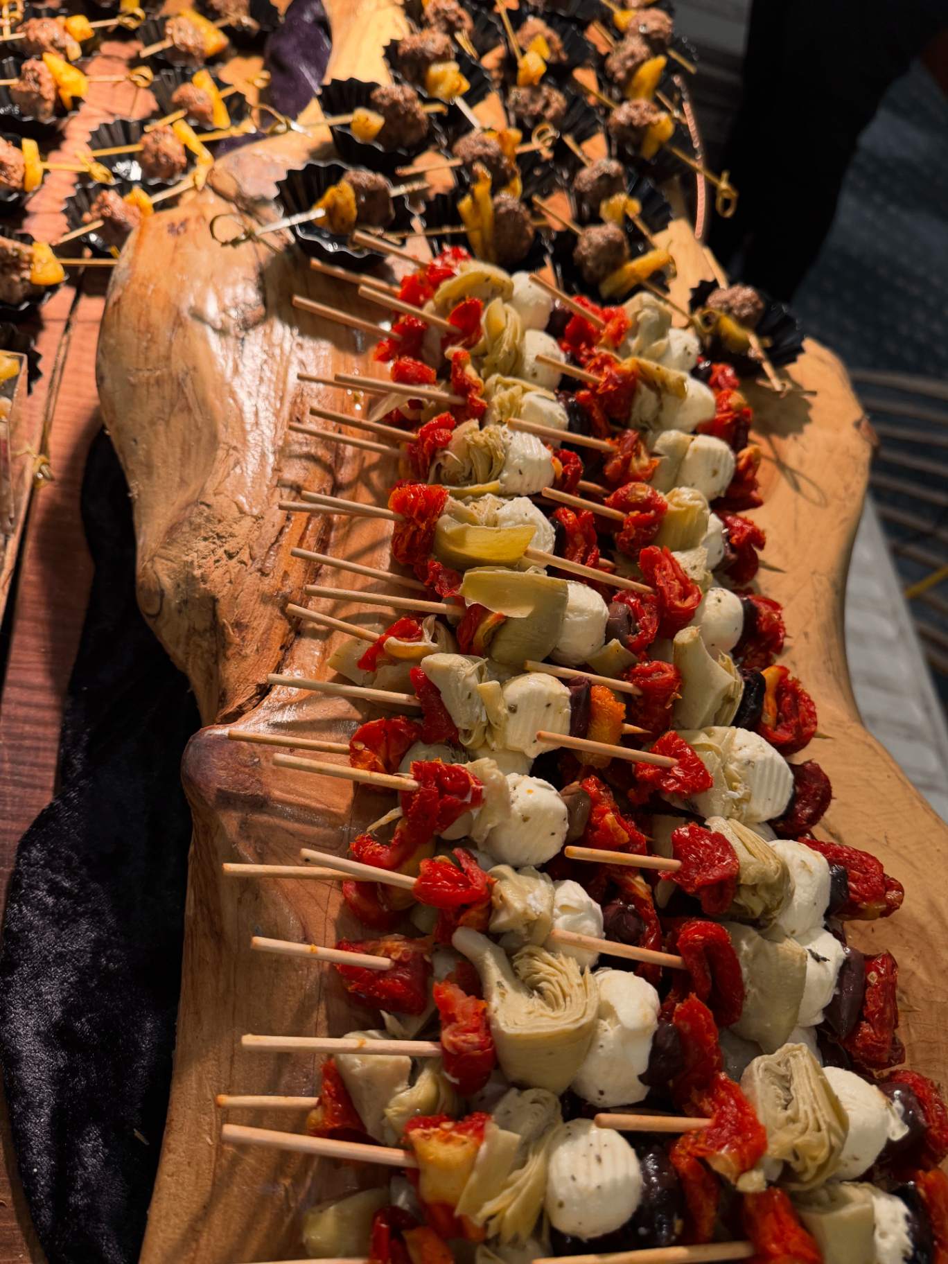 Antipasto and meatball skewers on a wooden board
